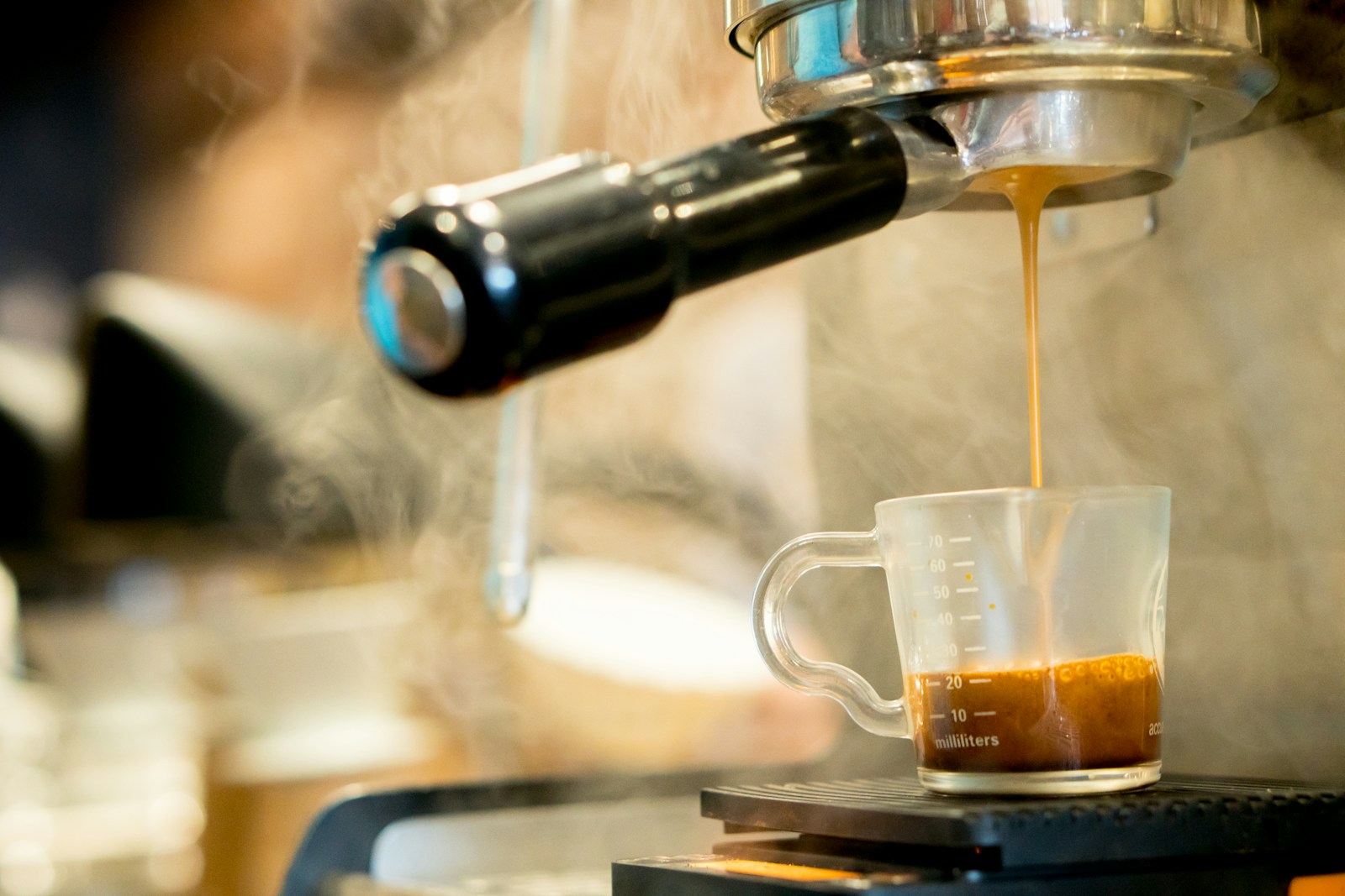 a cup of coffee being filled with liquid