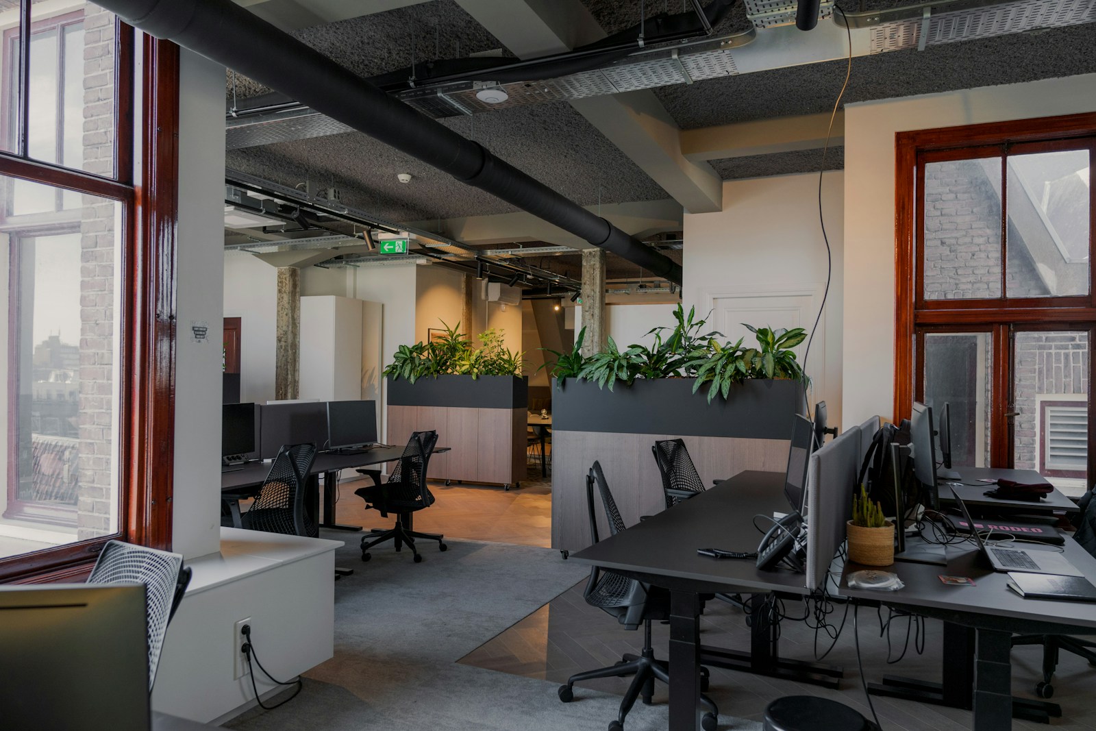 an office with a lot of desks and computers